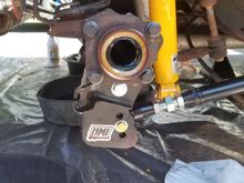 Pass side, the e-brake clips into that tab right under the axle flange