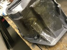 Cleaned the area several inches back from the damaged area, braced the broken pieces with vice grips and got to fiberglassing this thing back together.