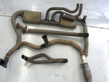 For those of you that don't know, the early 3rd gens had a crazy factory exhaust with small dual mufflers, this is the only picture that I could find.

The 2 pieces in the middle are the Y pipe and the intermediate pipe, that connected to the Y at the bottom that split into 2 smaller pipes going up over the axle, and on the other side the 2 smaller pipes went into the center pipe which went into the mufflers on either side and out the tailpipes.