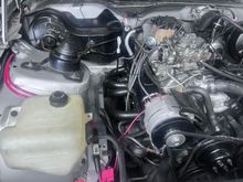 Overdrive Cadillac alternator pulley helps but limits engine rpm, dual 8 gauge power cables going through a pillar, LT1 battery cables.