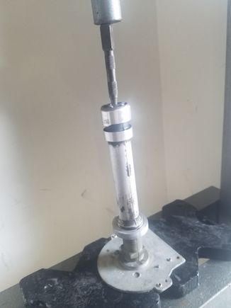 Using a nail punch to press the shaft complete out of the housing.