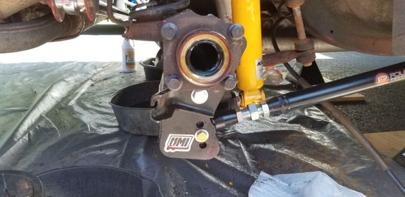 Pass side, the e-brake clips into that tab right under the axle flange