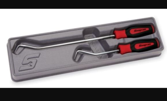 Use a hose pick. They are absolutely the best way to avoid damaging the hose or the heater core.