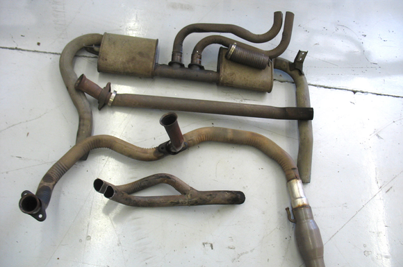 For those of you that don't know, the early 3rd gens had a crazy factory exhaust with small dual mufflers, this is the only picture that I could find.

The 2 pieces in the middle are the Y pipe and the intermediate pipe, that connected to the Y at the bottom that split into 2 smaller pipes going up over the axle, and on the other side the 2 smaller pipes went into the center pipe which went into the mufflers on either side and out the tailpipes.