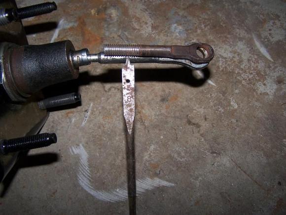 THIS IS THE PUSH ROD FROM THE OLD BOOSTER CUT AND THREADED LAYING ON TOP OF THE PUSHROD FROM THE HYDROBOOST. THE POINT OF THE WOOD BIT SHOWS WHERE I CUT THE BAR AND THREADED IT AT THAT POINT. TO HELP WHERE YOU CAN CUT THE PUSH BAR ON THE HYDROBOOST PUSH THE PUSHROD ALL THE WAY IN AND MARK IT 1/2" LONGER SO YOU CAN FULLY PRESS YOUR BRAKE.