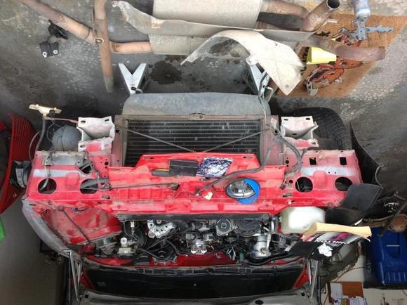 Front engine bay showing the places needing fixed. Frame rails and radiator support bracket. Sorry it's upside down. Can't seem to flip it