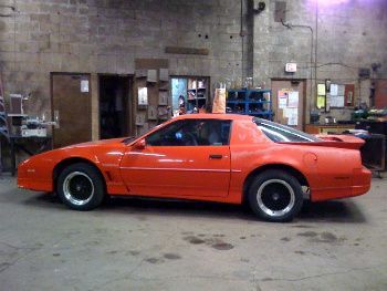 Temporary 305 TPI engine (incomplete) installed. Ready to be towed home! Still needs everything else to make it run, though.