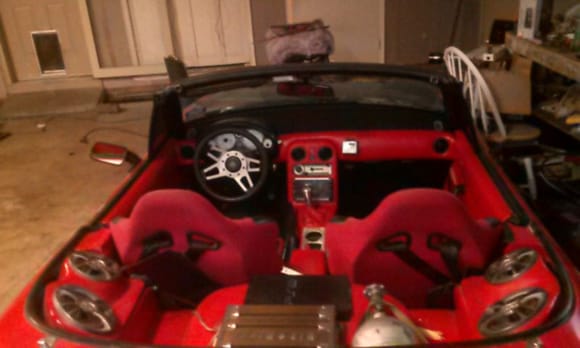 Good view of the interior from the back. You can see the NOS bottle and Hifonics amp for the subs.
I put a Grant GT wheel on it, but there is no steering column adjustment so the smaller wheel kind of cuts off the top of the gauge cluster.