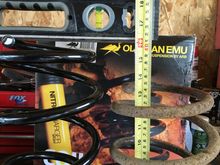 13 5/8" on fatigued factory rear spring w/o load.  OME non-fatigued #990 spring measures 16".  That is at LEAST 2.5 to 3" difference.