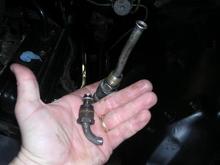 new fitting installed and hose straightened and flared, old fitting also shown