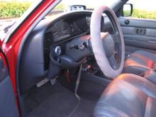 the altimeter/clinometer is up on the dash...

I don't really like the steering wheel foam, but it was a bday gift and California traffic makes me grip the wheel extra hard, so it stays!  That small dial to the left of the steering column is a cheapy aftermarket ambiant thermometer.  

Notice the tweeters in the door panels.  Thanks Aunt Marsha!