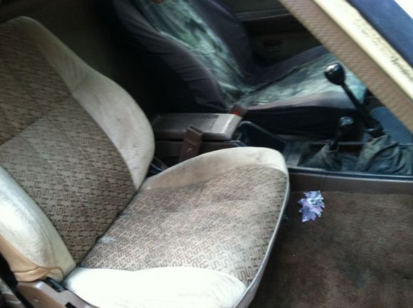 Pulled one of the 30 year old sweaty farmer butt seat covers to reveal some sr5 seats! I'm into the look but the driver's side has me riding on the rear seat cross rail.  I'd like to get new cushioning in them.  Maybe some junk yard yota seats in the future though.