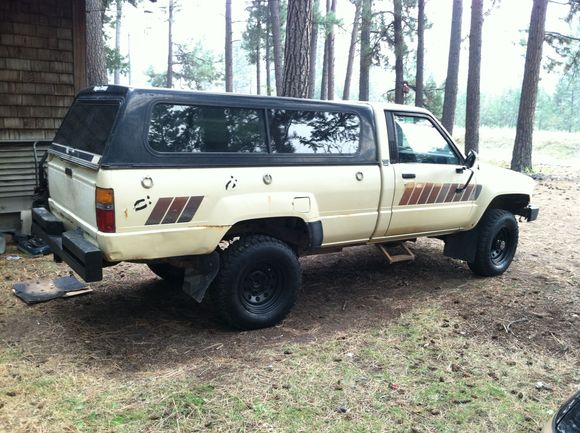 hit the junkyard and scored a somewhat color matched (rattle can maybe) tail gate from a 2wd with a jap bed.  It fits decent and i kind of like the jap roll to the outside for the tailgate.  semi useful and helps with water run off from the topper. Also scored all the light covers i need to get legal.  OEM baby!