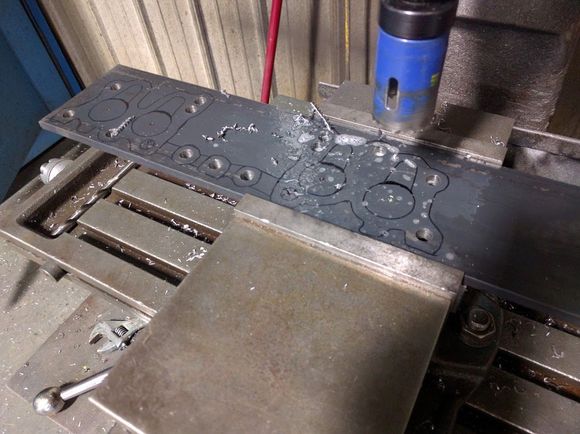 Drilling exhaust ports with hole saw in mill.