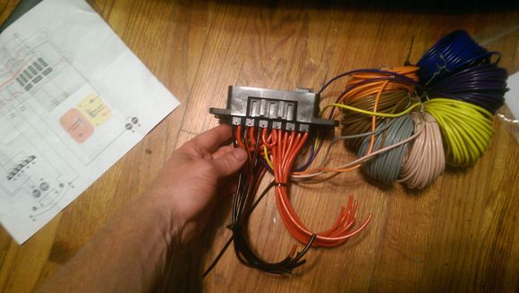 Red 12ga will go to a + busbar and leads into the fuses, then to the relays.  Black (with red stripe) 12ga will go to a grounding busbar.  Colorful spools will be run through the firewall to the switches with other wiring going to the interior.