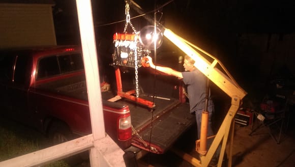 Some tricky maneuvering to get the engine and the stand loaded up in the back of the truck.  Notice the powerline coming in =)
