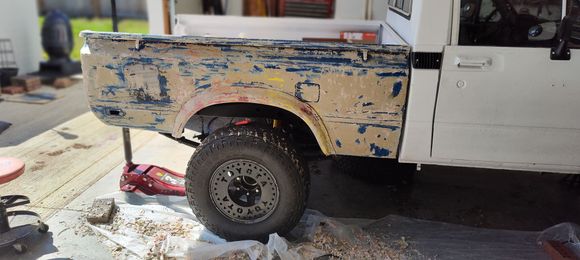 Stripping the bed liner stuff off the bed.