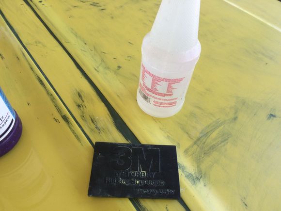 A drop of dish soap in a spray bottle with water help by not making such a mess as a bucket full of water. The small amount of soap helps lift the old paint away from your work area. A 3m squeegee is great for keeping the area your working on free from debris and helps you see where you need more sanding. Normally I would use an engineering fluid called Dykem between grits but I can see well on this color without it