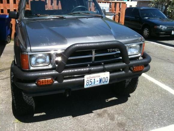 Smittybilt bumper with Rhino Lining coating and 3&quot; drain plugs in ends for bungee and rope storage.