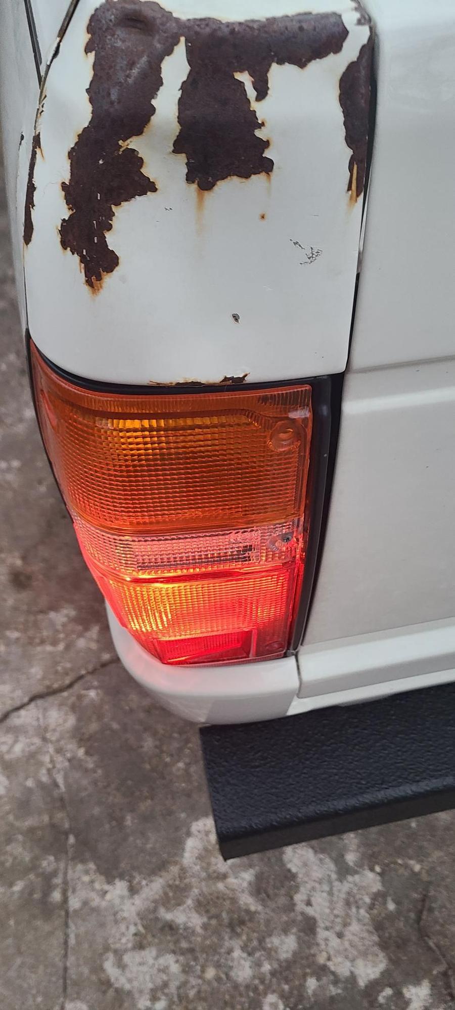 Driver side. When the tail light is lit, no bleed through into reverse reflector