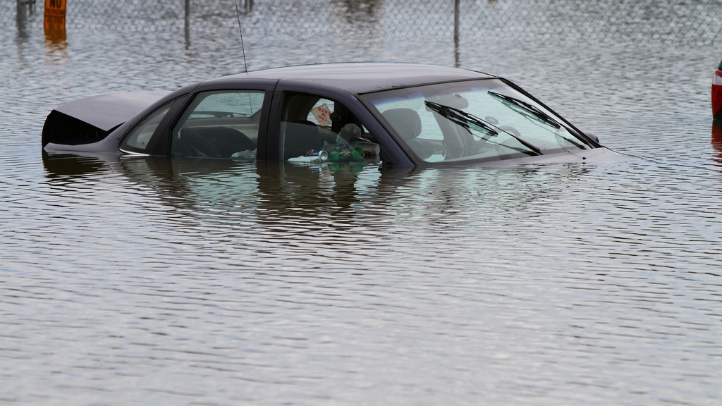 Flooded car in parking lot. Photo via Flickr user waitscm/CC2.0