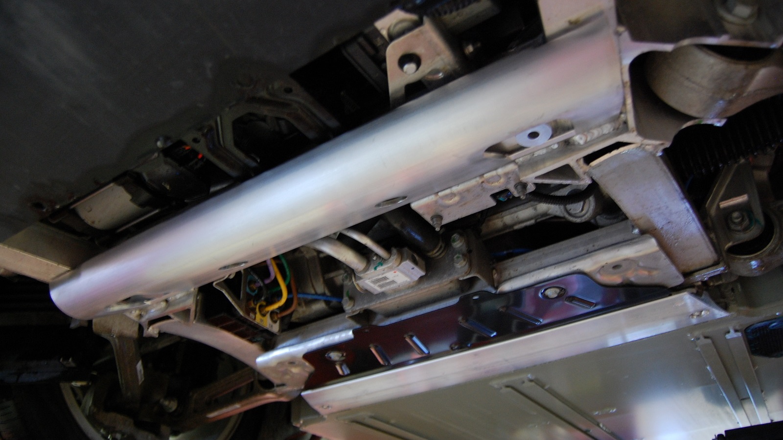 Tesla Model S added battery shield - half-tube, black titanium plate, T-section, from front to rear