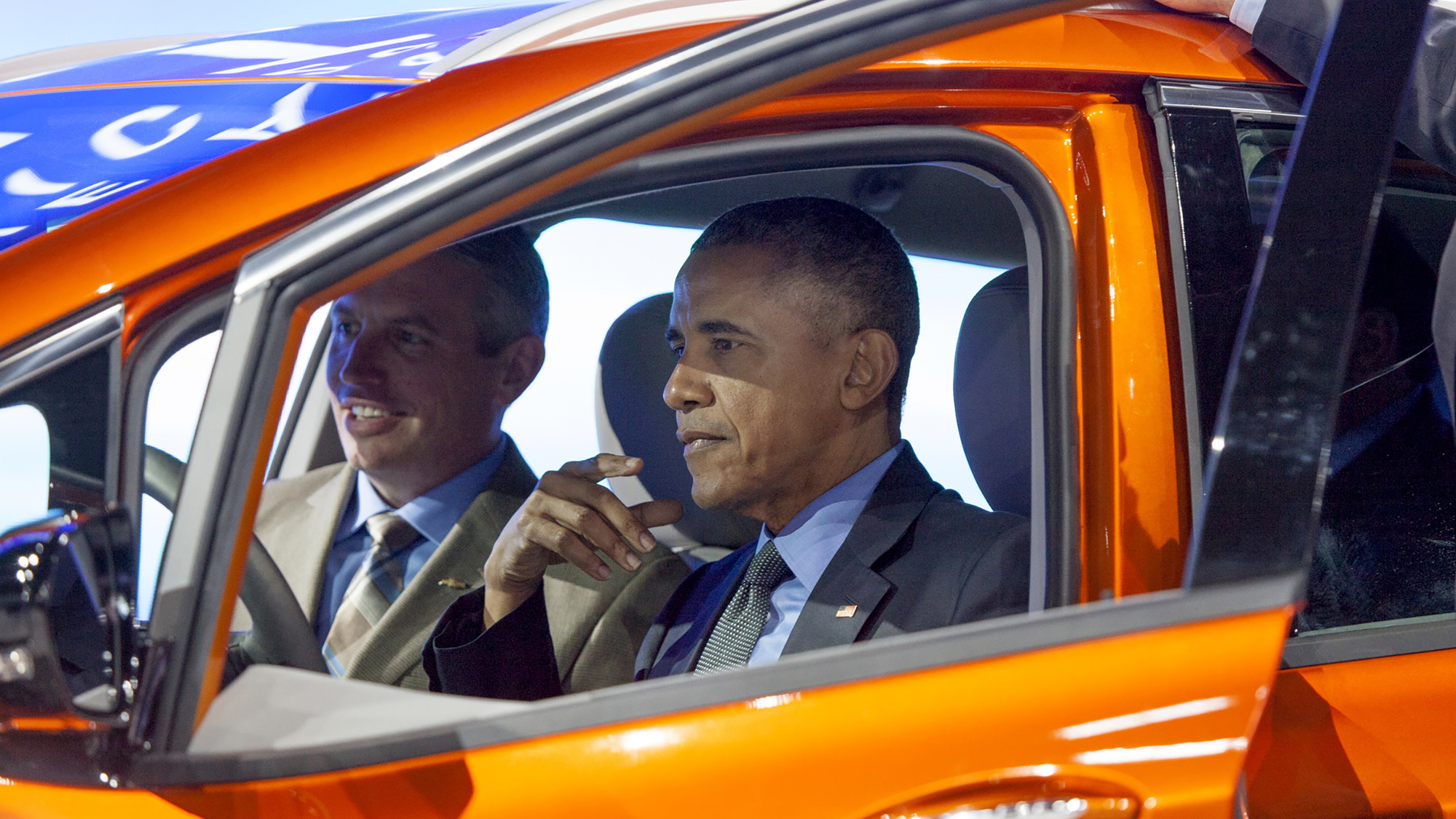 President Barack Obama sits in 2017 Chevrolet Bolt EV electric car at Detroit Auto Show, Jan 2016