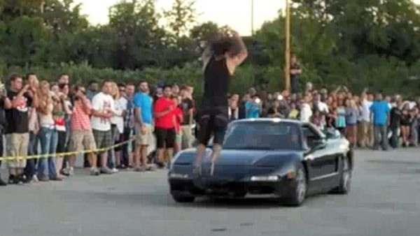 Man completes jump over moving Acura NSX